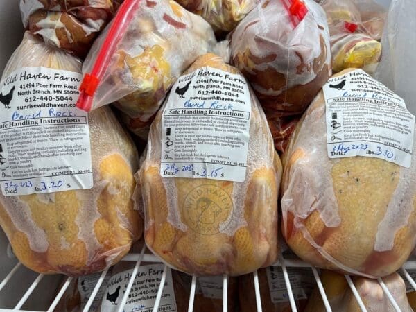 Frozen whole chicken stacked in freezer