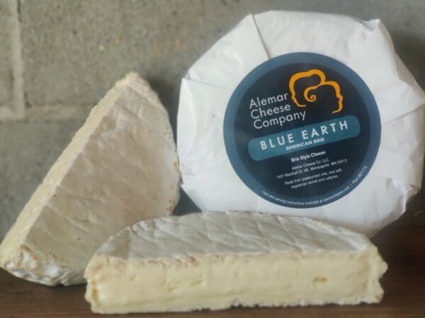 Alemar Blue Earth Cheese packaged wheel with a cut wheel of cheese