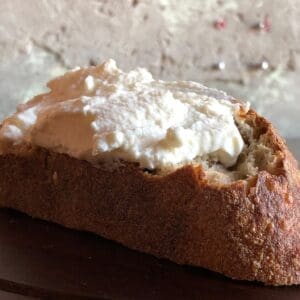 Alemar Fromage Blanc cheese on a piece of bread