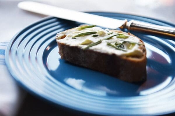 Alemar Fromage Blanc on bread on a plate with a knife