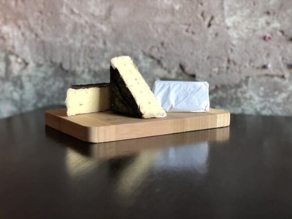 Alemar's Sakatah cheese cut and on a wooden board